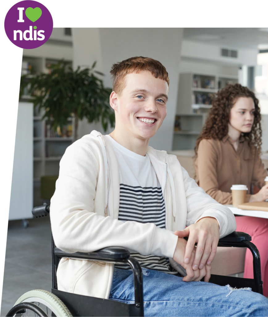Guy in wheelchair smiling in classroom