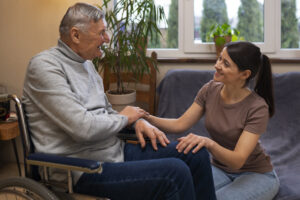 elderly person being taken care by female caretaker